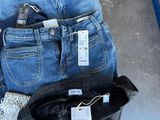 several pairs of jeans are stacked on top of each other