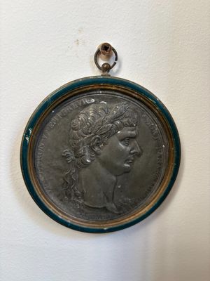 an old silver coin with a woman ' s face on it