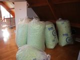 several bags of rice sitting on top of a wooden floor in a room