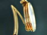 a close up of a watch with a gold band