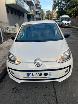 a white volkswagen up parked on the side of the road