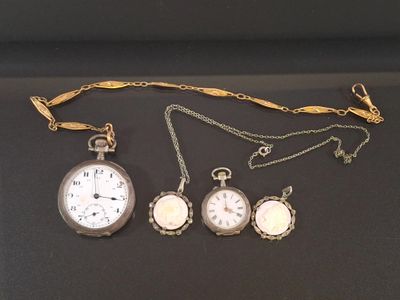 three different types of pocket watches are displayed on a black surface