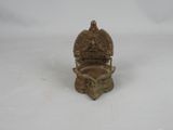 brass figurine of a buddha on a throne with a crown on top