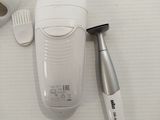 a toothbrush, toothpaste, and toothbrush holder on a table