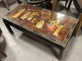 a glass table with a painting on it in a room