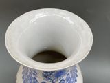 a blue and white vase sitting on a table
