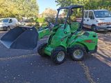 a green tractor that is parked in a parking lot