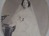 an old photo of a woman in a wedding dress