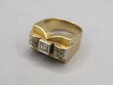a gold ring with two diamonds on it