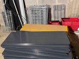 a stack of black plastic sheets sitting on a pallet