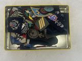 a picture of a metal tray with a lot of patches on it