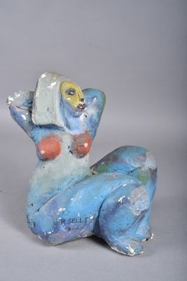 a blue and white figurine of a cat with a fish on its back