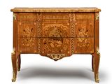 a wooden chest of drawers with carvings on it