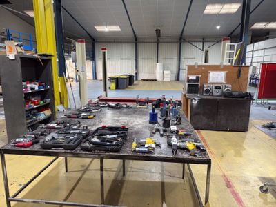 une table sur laquelle sont posés des outils, dans un entrepôt
