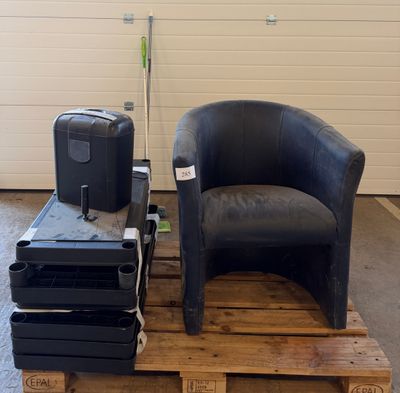 a chair and a suitcase on a pallet in a garage