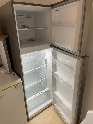 an open refrigerator in a small kitchen with the door open