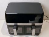 a black and silver toaster sitting on a counter