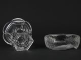 two clear glass bowls sitting next to each other on a black surface