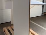 a white refrigerator sitting on a pallet in a garage