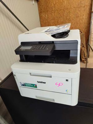 a printer sitting on top of a cabinet in a room