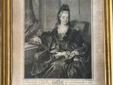 an old picture of a woman sitting in a chair with a cat