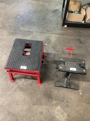 two tools are sitting on a table in a warehouse