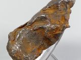 an image of a piece of rock sitting on top of a glass stand