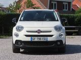 a small white car parked in front of a house