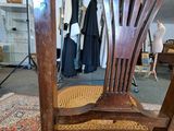 a wooden chair that is sitting in a room