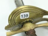 a close up of a sword with a tag on it