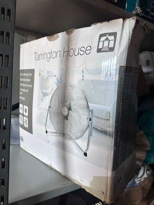 a box of fan sitting on a shelf in a room