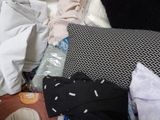 a cat that is sitting on a bed with a lot of pillows