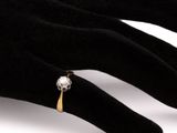 a person ' s hand with a diamond ring on it