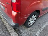 a red van parked on the side of the road