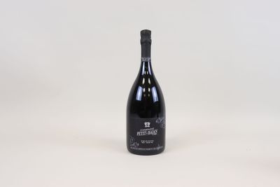 a bottle of wine sitting on top of a white table