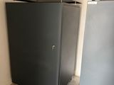 two steel lockers in the corner of a room