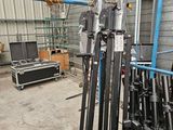 many skis and ski poles in a rack in a building