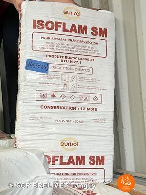 a man standing next to a stack of bags of food