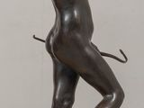 statue of a woman holding a tennis racquet on a wooden table