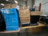 many boxes of electronics sitting on a table in a warehouse