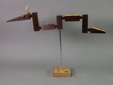 a sculpture made of wood and metal on a stand