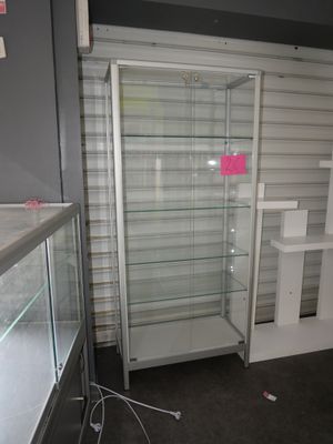 a glass display case in the corner of a room