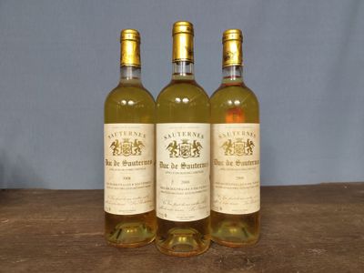 three bottles of wine sitting on top of a wooden table