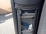 a black stove sitting on top of a wooden pallet