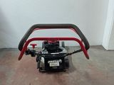 a small engine sitting on the floor in a room