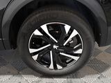 a close up view of a car ' s wheel on the ground