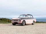 a pink car that is parked on the side of the road