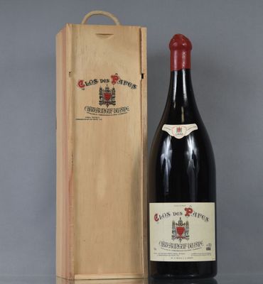 an old bottle of wine sitting next to a wooden box