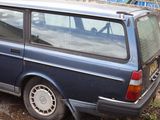 a small blue van parked on the side of the road