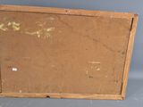 an old picture frame with a piece of brown paper on it